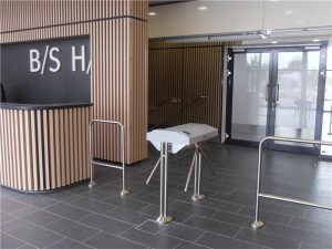 Einzigartiges B/S/H-Zugangssystem: Drehkreuzeingang und Designdetail mit Holzlamellen in der Anlage